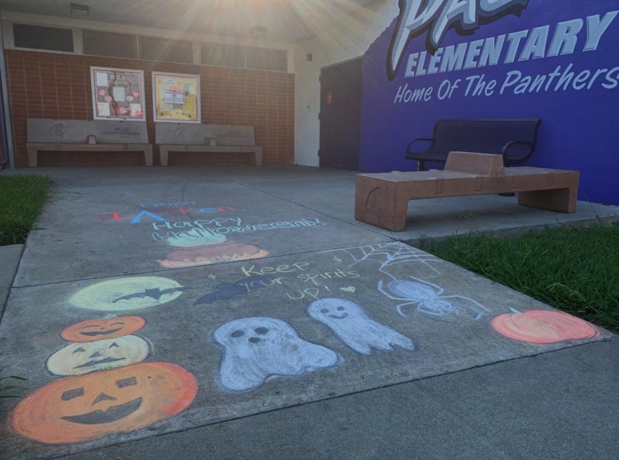 Renaissance Promotion committee members brighten up the campus of Palm Elementary School with chalk art just in time for Halloween. Photo by Giovanna Fernandez