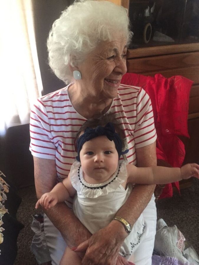Anita Acuña smiles wide with her grandchild, reflecting on the Polio epidemic during a new pandemic, COVID-19. Photo by Lauren Stratton. 
